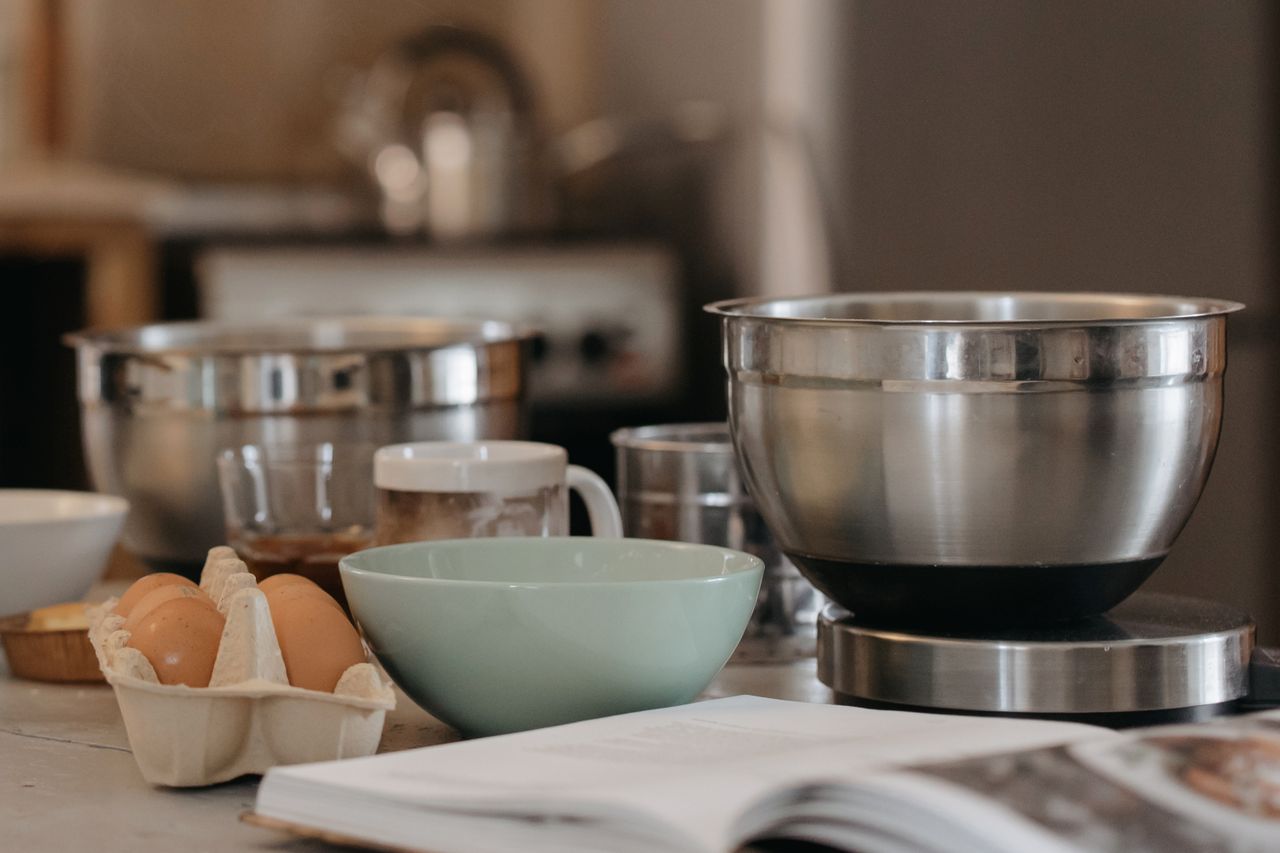 services-02 A cozy kitchen setup with baking bowls, eggs, and kitchen utensils for a comforting cooking experience.